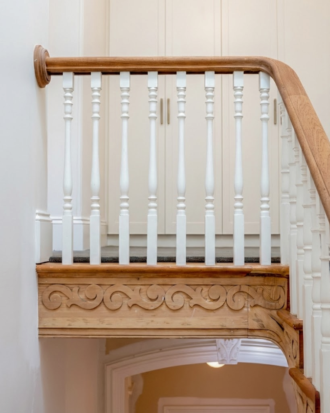 Restored Adelaide staircase landing with carved timber detail and white balustrade