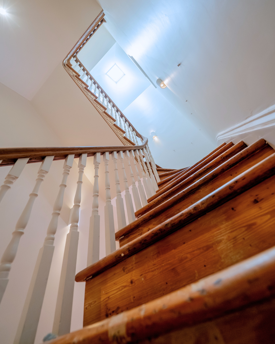 Old Adelaide home staircase with polished timber treads, handrail and tall stairwell