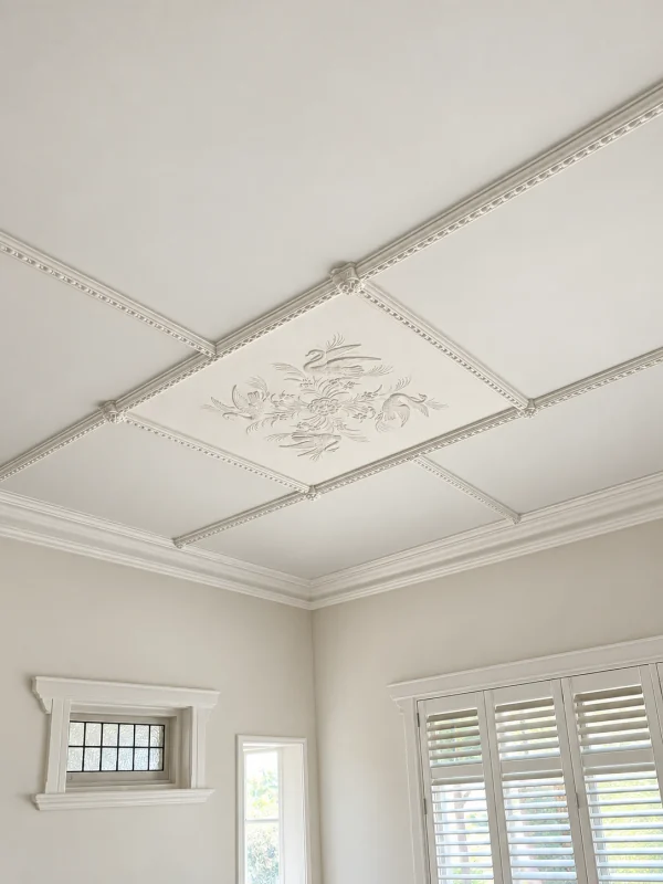 Finish visualisation of a swan-patterned decorative plaster panel framed by ceiling battens