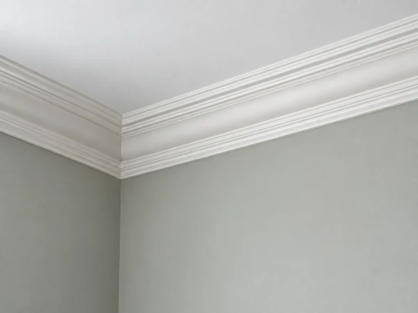 AI-assisted finish visualisation of a white moulded cornice above grey-green walls in soft daylight