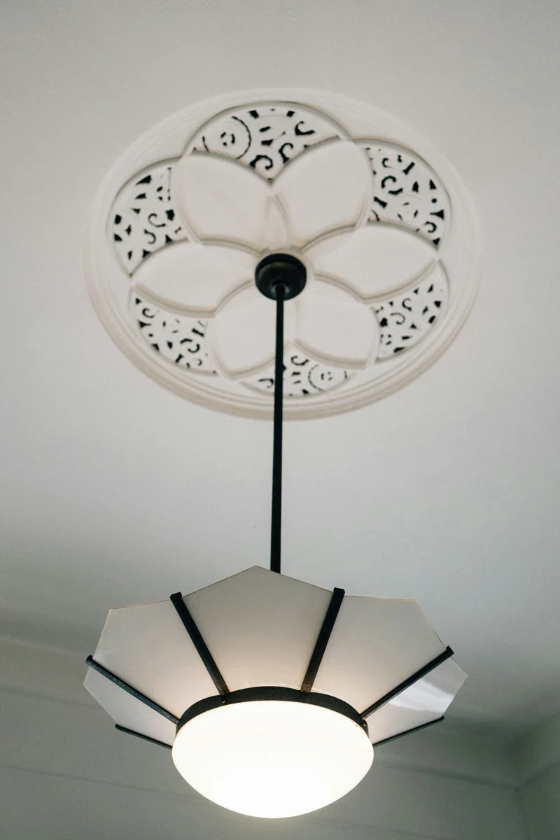Reference photograph of a plaster ceiling rose with a hanging light