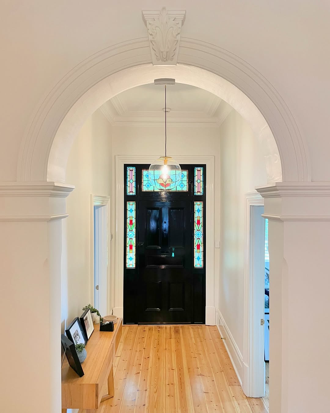 Restored Mitcham hallway with arch, corbel detail and stained glass front door