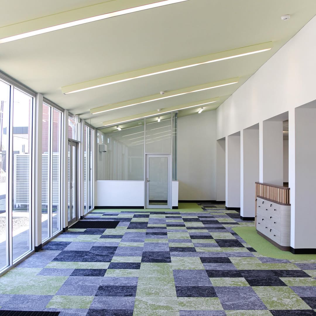Renovated Mount Carmel College library area with patterned carpet tiles and glazing