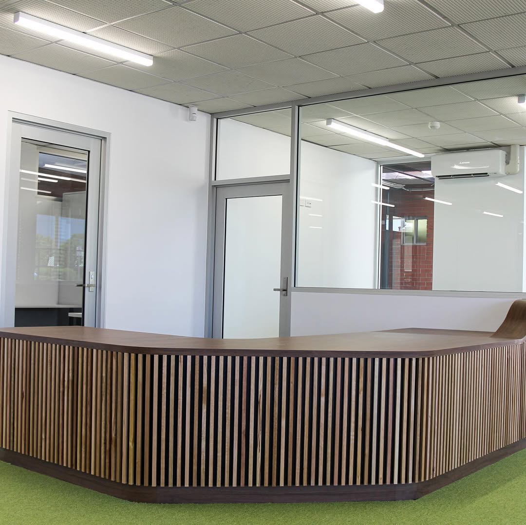 Curved timber slat library counter at Mount Carmel College