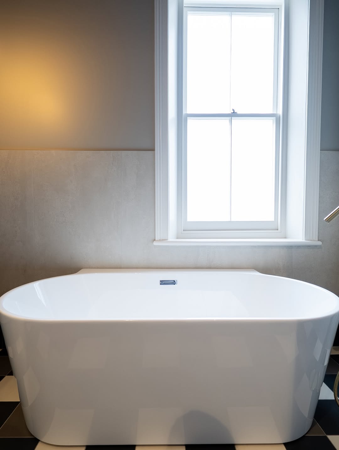 Freestanding bath beneath the window in the North Street en-suite